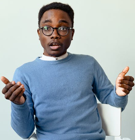 man in blue long sleeve shirt talking
